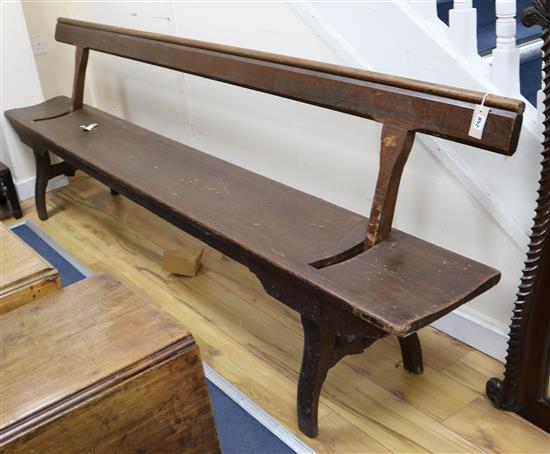 A late Victorian / Edwardian pitch pine railway bench with adjustable back W.273cm